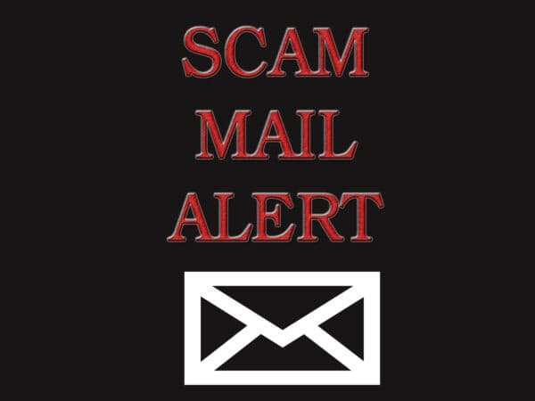 Scam mail alert banner. Red Scam alert text above a white envolop on a black background. created by V in Photoshop CS4.