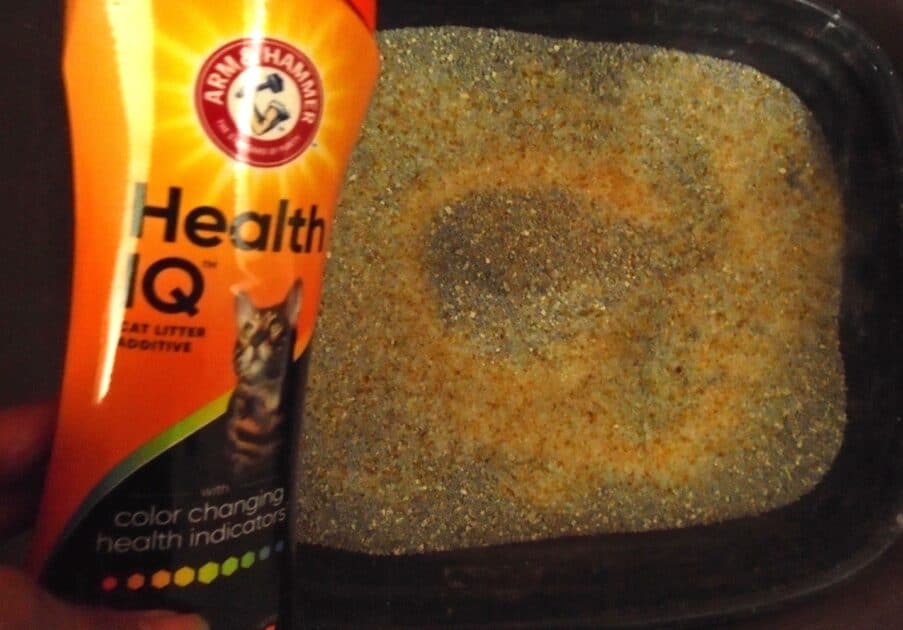 Arm & Hammer Health IQ bottle heald over the litter box. Health IQ srystals in box.