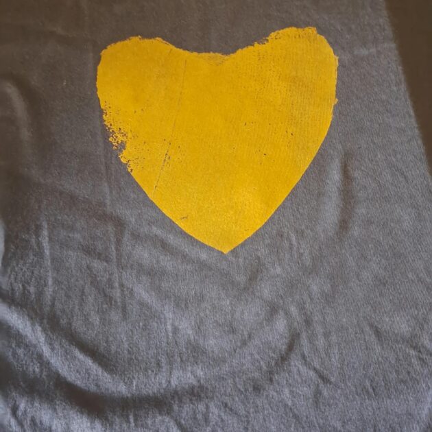 gold heart on a t-shirt.