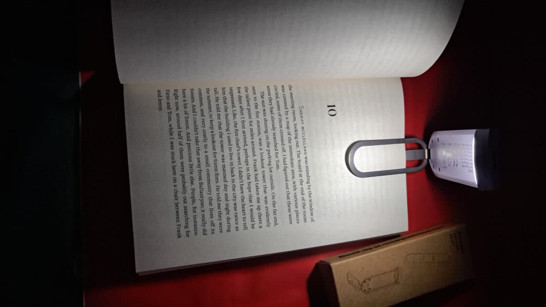 Akomid Book Light light clipped to book. light on.