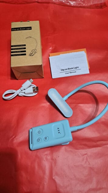 AXX Clip on Book Light, box, USB charging cable and directions.